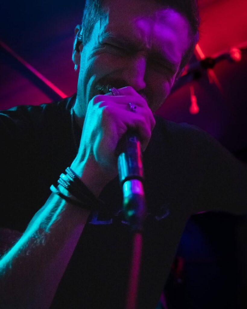 Ted Claxton singing into a microphone
