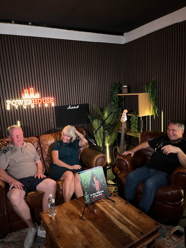 Three people laughing during a podcast recording in the Powerhouse Studios podcast room