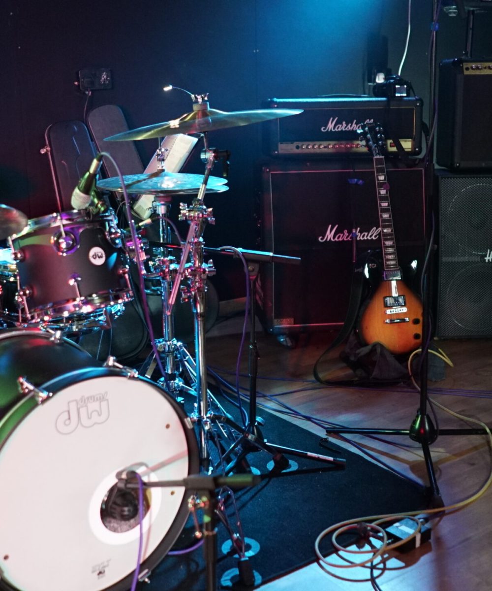 A band set up in Room 6 for a rehearsal at Powerhouse Studios with a drum kit, Marshall and Vox amps and a selection of various guitars including Gibson guitar